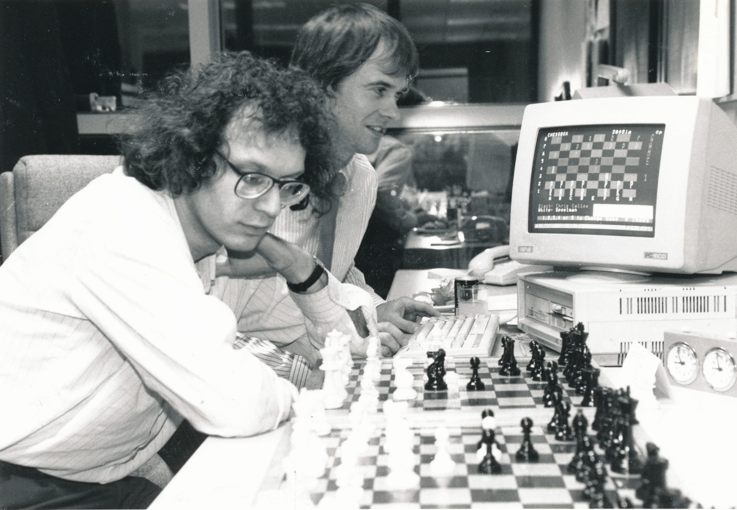 Grandmaster Uses PressTel Chessbox to Play Long Distance Chess. Jonathan Speelman the UK Grandmaster is pictured here deciding his next move in a computer chess game against five simultaneous opponents. Players exchanged moves online via the ChessBox club on PressTel, BTs videotex service.