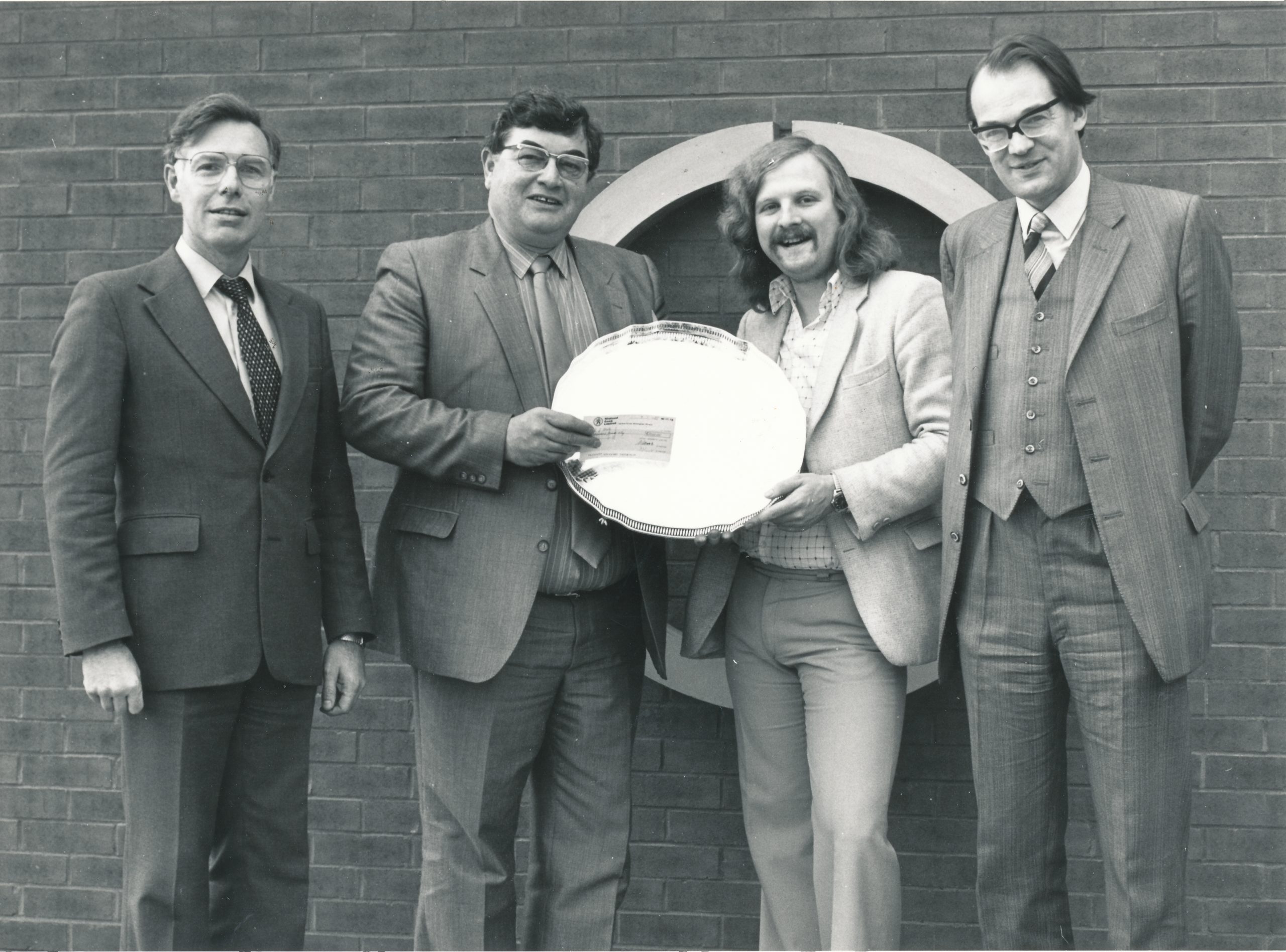 Tony receives the 1984 Leigh Grand Prix award from Dr. A Kent, Malcolm Wood (Chief Executive) and David Anderton OBE