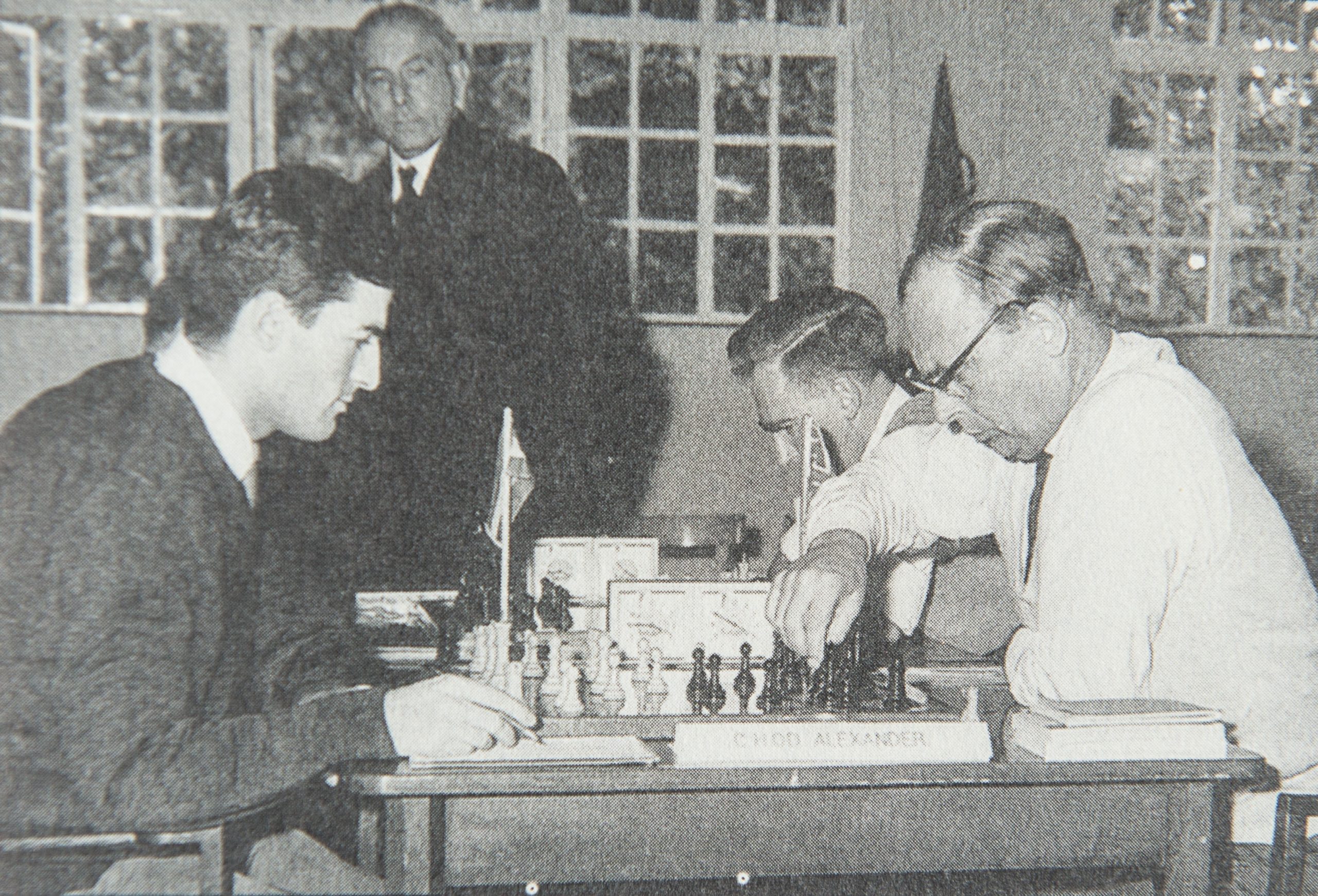 Kick Langeweg plays Hugh Alexander in the Anglo-Dutch Match of October 7th , 1961. Peter Clarke (right) is playing Johan Teunis Barendregt and Harry Golombek observes