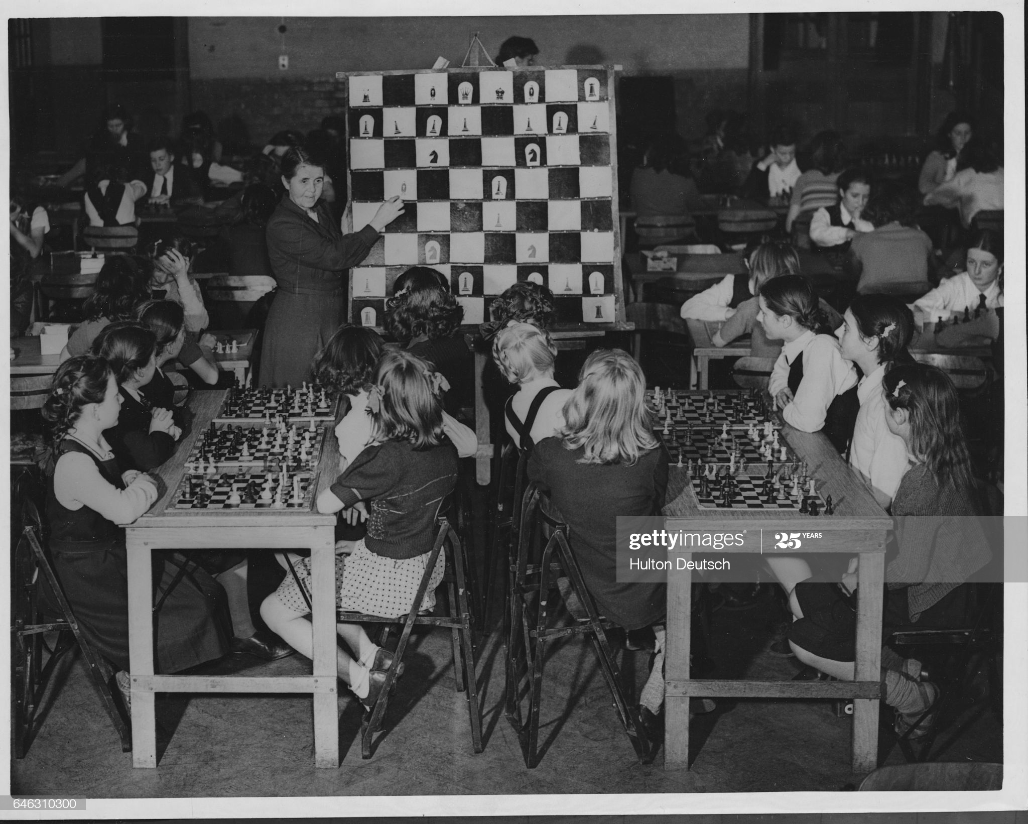 A class of girls listens to their teacher Lucy Anness give a lesson on the game of chess at a school in Bromley, Kent, England, in 1948. Miss Anness, head of the school, believes this is the only girls' school in Britain at this time that teaches chess as part of the curriculum. (Photo by © Hulton-Deutsch Collection/CORBIS/Corbis via Getty Images)