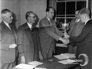 Mr A Corish (right), receives the Chess Champion cup from Mr J Adams. 18th September 1958 from the Merton Advertiser, Photographer unknown.