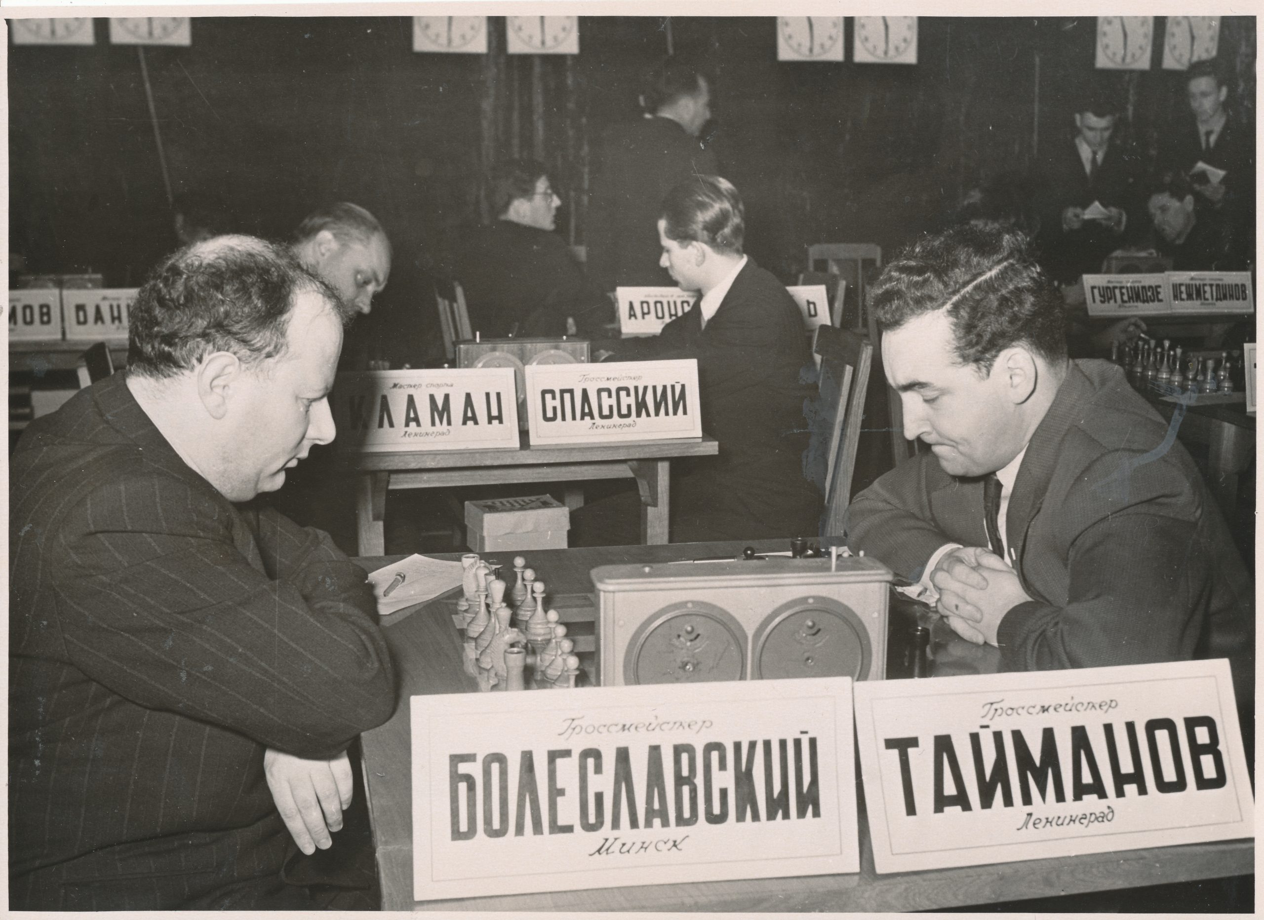 Isaac Boleslavsky plays Mark Taimanov in round one of the 24th USSR Championship on January 21st 1957. Peace broke out after fifteen moves of a Nimzo-Indian Defence